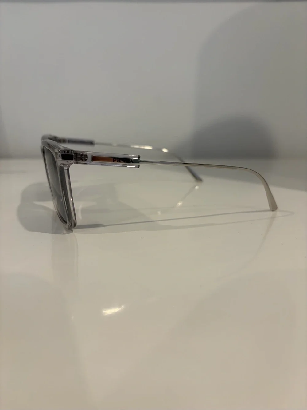 Prada Men’s Clear Frame Sunglasses with Dark Blue Lenses